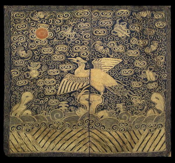 Dark navy textile with intricate gold swirling cloud and bird motifs over geometric waves.