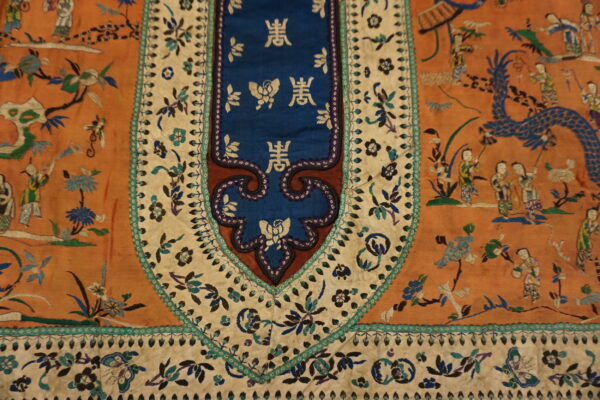 Highly detailed rust textile featuring embroidered figures, a blue dragon, and a central blue panel with gold script.