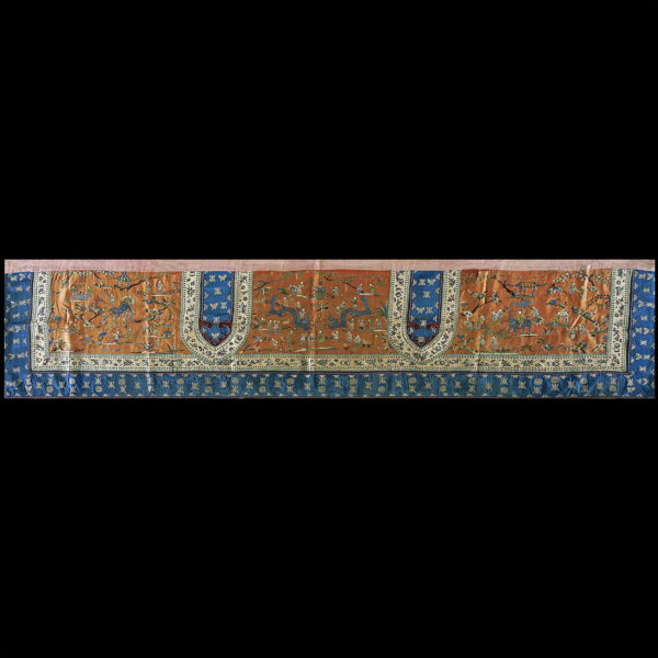 A detailed, flat-woven rug or textile featuring a sienna field, blue borders, and gold embroidered figures.