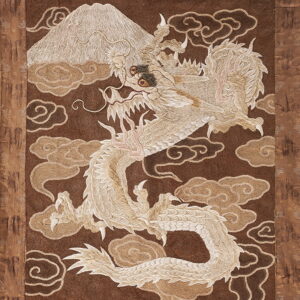Textured brown textile featuring a large cream dragon, mountain, and stylized cloud pattern.