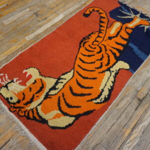 Low-pile runner with a vibrant orange tiger pattern and navy accents on distressed gray wood planks.
