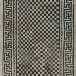 Textural off-white and dark brown rug featuring a checkerboard field and geometric meander border.