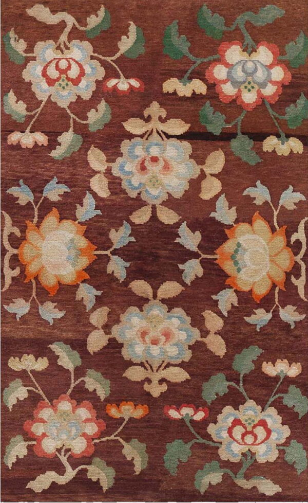 Reddish-brown rug featuring stylized floral motifs in cream, pale blue, orange, and green.
