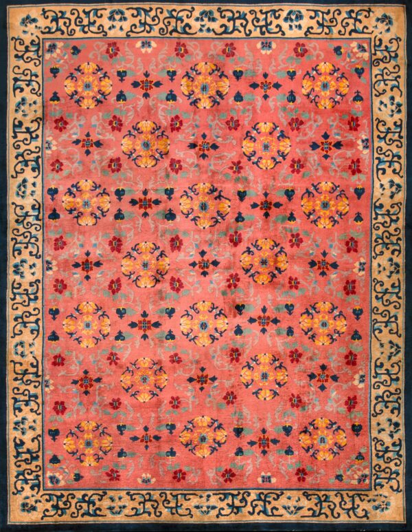 Close-up of a high pile rug in rust, navy, gold, and teal with a visual tag attached near a folded edge.