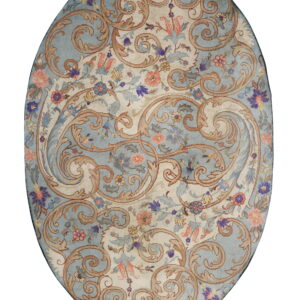 Ornate oval rug displaying tan scrolls and multi-colored flowers across alternating blue and ivory fields.