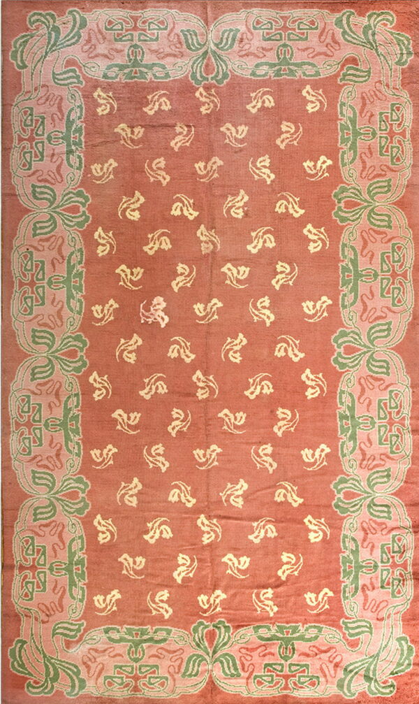 Low pile rug with a rosy-red field, scattered pale yellow motifs, and an elaborate border in sage green and pale pink.