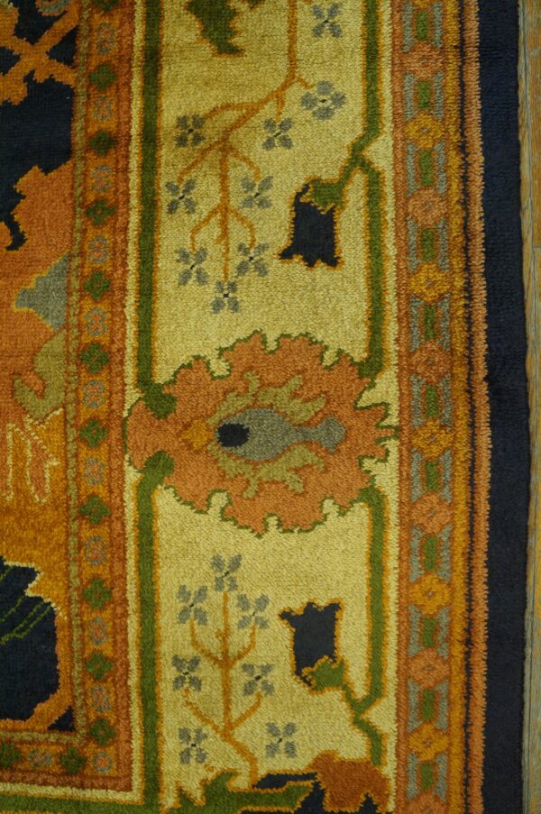 High-pile rug detail showing floral patterns in yellow, orange, navy, green, and gray.