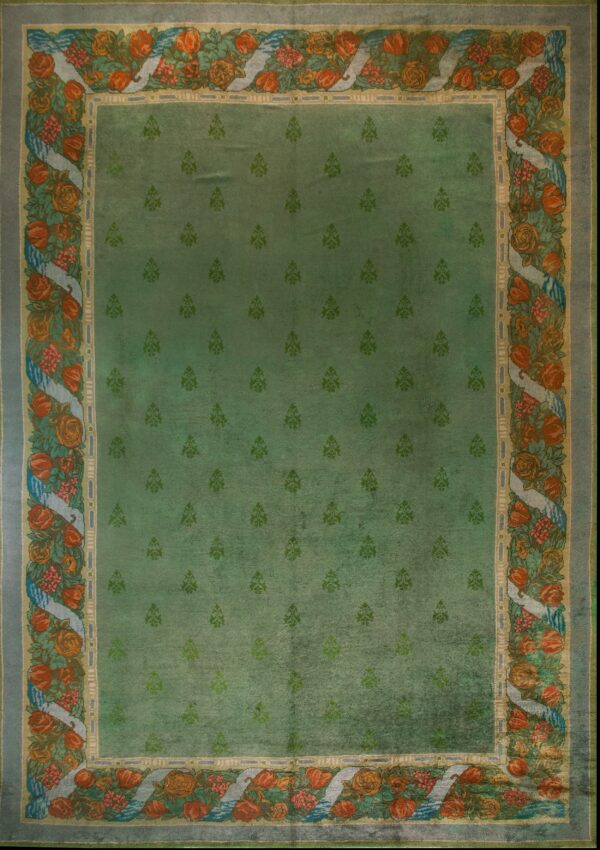 Green rug with floral border design.