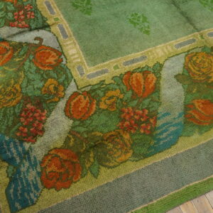 Floral patterned green wool area rug