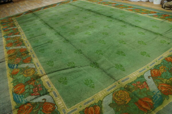Large green floral patterned area rug