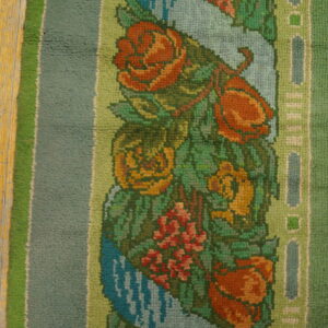 Colorful floral pattern on green rug