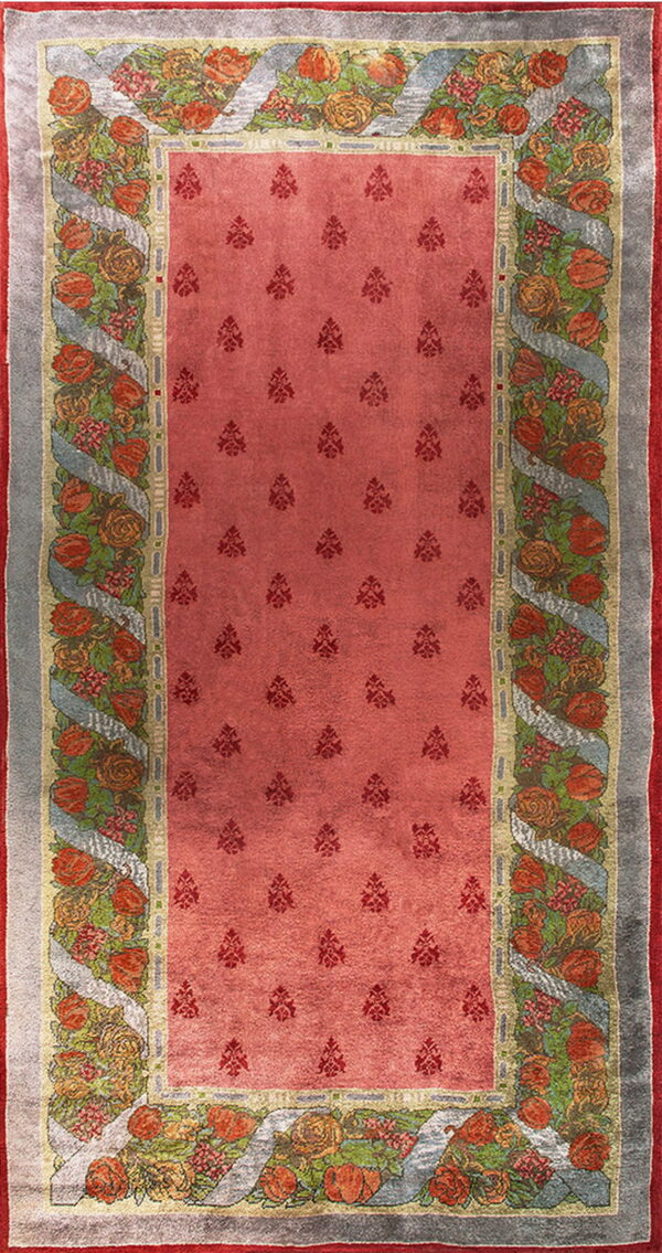 Red runner rug featuring dark small motifs and a border of colorful roses intertwined with gray ribbon.