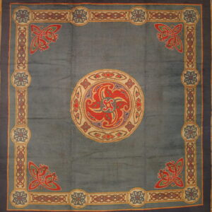 Blue rug with a large red, purple, and cream central medallion and complex multicolored knot border design.