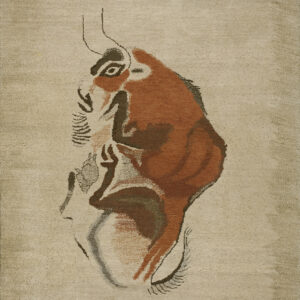 Low-pile beige rug displaying a stylized profile of an animal face patterned in rust, brown, and black.