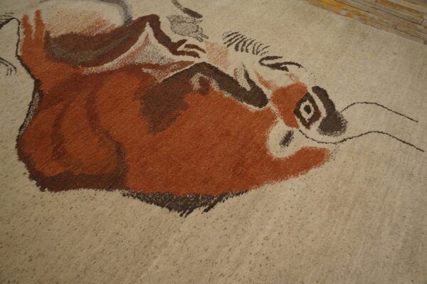 Expressive vintage ecuadorian pictorial art rug from ecuador 3 Textured beige rug featuring a painterly rust and brown abstract animal design near distressed wood flooring.