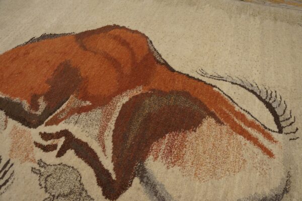 Expressive vintage ecuadorian pictorial art rug from ecuador 6 Textured beige rug featuring a prehistoric-style animal design rendered in rusty orange and dark brown.