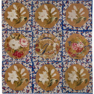 Square rug with nine tan medallions displaying flowers and a central bird on a blue, densely patterned field.