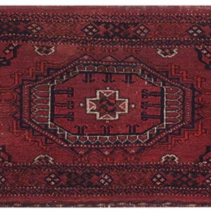 Deep red runner rug with a tribal geometric pattern highlighted by dark blue and off-white details.