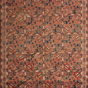 Geometric rug featuring a grid of squares with complex star-like motifs in red, navy, teal, and tan tones.