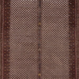Geometric maroon and tan rug featuring an arched top and a central field of repeating diamond motifs.