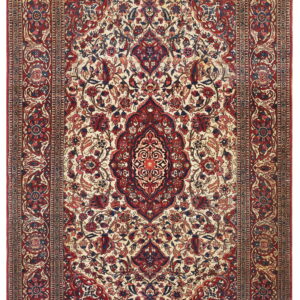 Red and navy traditional rug with a central medallion and dense floral design on a cream field.