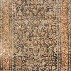 Long runner rug featuring a faded navy and tan traditional pattern with a distinct arched top end.