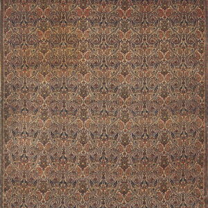 Ornate low-pile rug featuring a dense repeating traditional pattern in navy blue, rust, and cream tones.