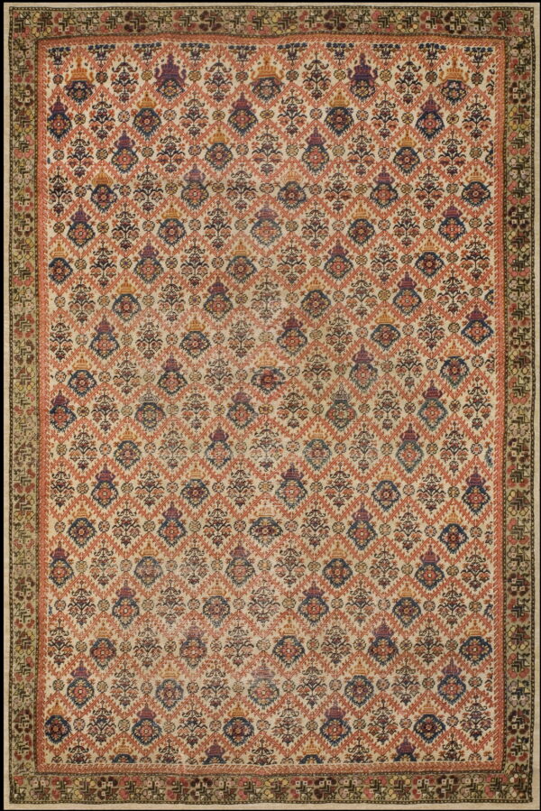 Faded cream rug with an intricate repeating floral diamond pattern in rust, blue, and purple colors.
