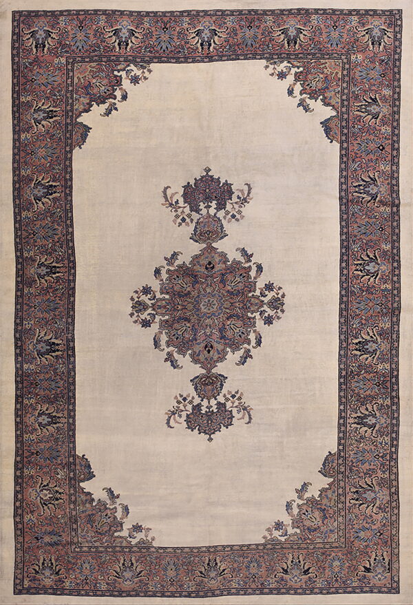 A traditional cream rug with a rose and blue central medallion and matching detailed borders.