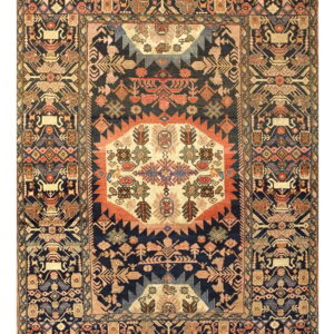 Dark blue rug with a dense geometric pattern in ivory, rust, gold, and muted earthy tones.