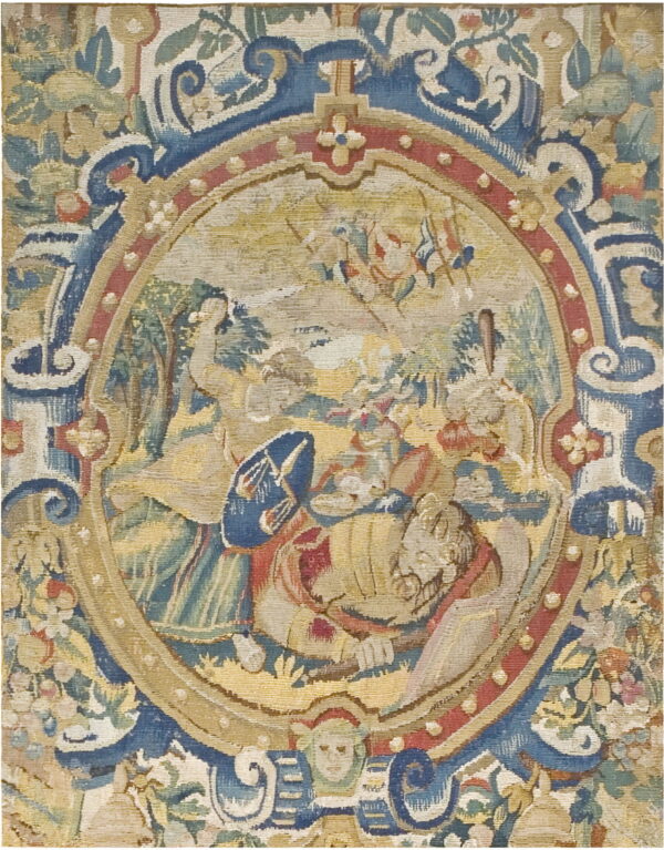 Low-pile tapestry in muted gold, blue, and red with a central medallion depicting figures and surrounding floral scrollwork.
