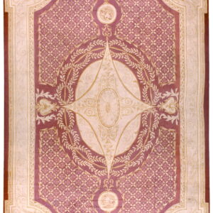 Mauve and ivory traditional rug with a central medallion, ornate lattice field, and foliage borders.