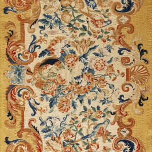 Ornate flat-weave rug featuring a cream floral center surrounded by a golden border of scrolling blue and red patterns.