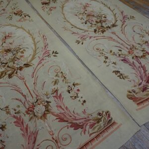 Ornate sage rugs featuring delicate pink florals, scrolling acanthus, and stylized creatures on wood flooring.