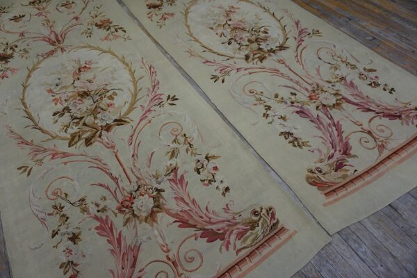 Ornate sage rugs featuring delicate pink florals, scrolling acanthus, and stylized creatures on wood flooring.