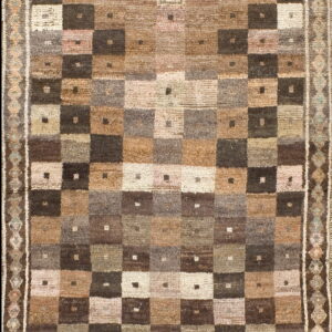 Rustic high-pile rug displays a muted brown and tan checkerboard pattern with subtle geometric borders.