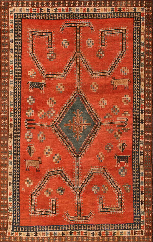 Terracotta rug featuring a dark blue central diamond, stylized animals, and complex multicolored borders.