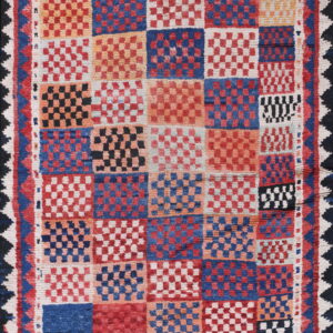 Textured rug featuring a bold checkerboard grid pattern in red, blue, orange, cream, and black, with geometric borders.