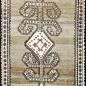 Striped beige and brown rug with a prominent white geometric totem motif and multicolored floral borders.