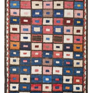 High-pile rug with a grid of multicolored squares framed in dark brown, featuring blue, red, and cream.