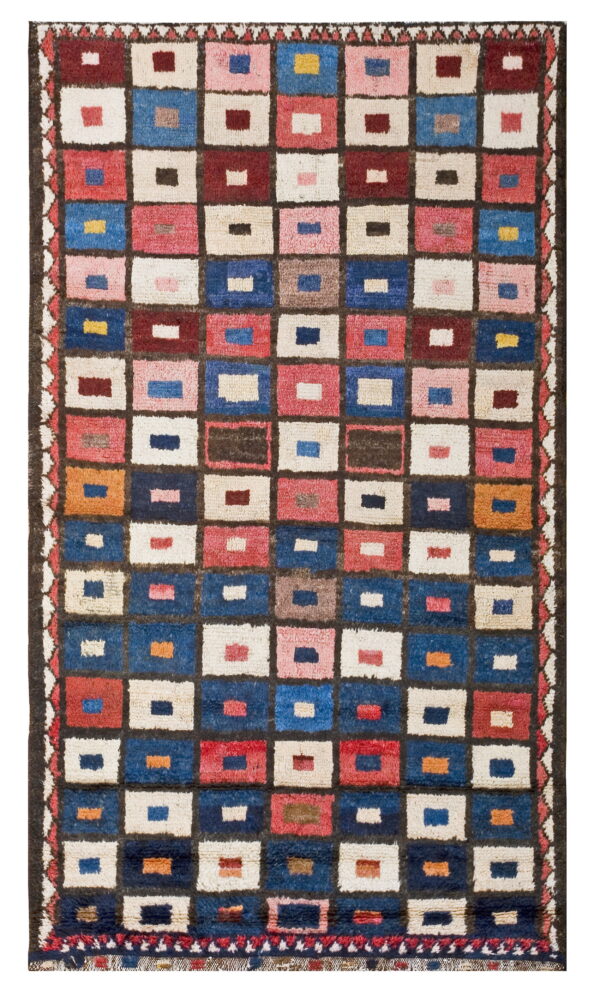 High-pile rug with a grid of multicolored squares framed in dark brown, featuring blue, red, and cream.