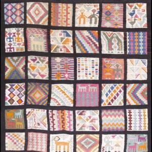 Colorful tapestry-style rug designed in a grid of squares containing varied geometric and figurative motifs.