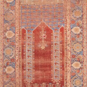 Antique rug with intricate floral patterns.