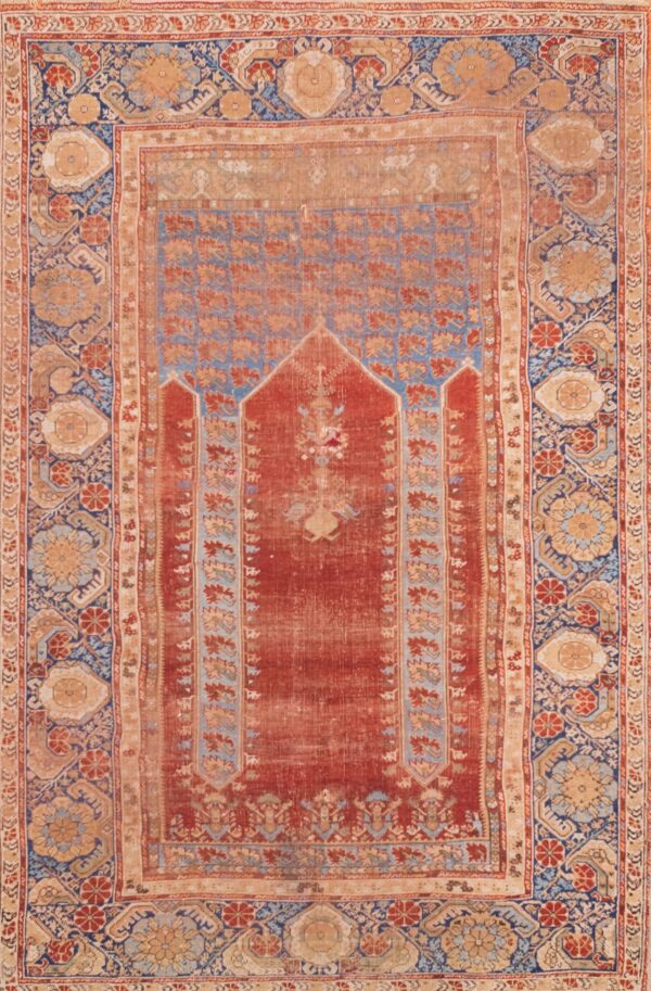 Antique rug with intricate floral patterns.