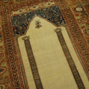Floral rug featuring a light yellow arch field surrounded by detailed red, blue, and olive geometric borders.