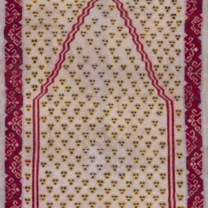 A woven rug featuring a cream field with yellow motifs and a deep red prayer niche design.