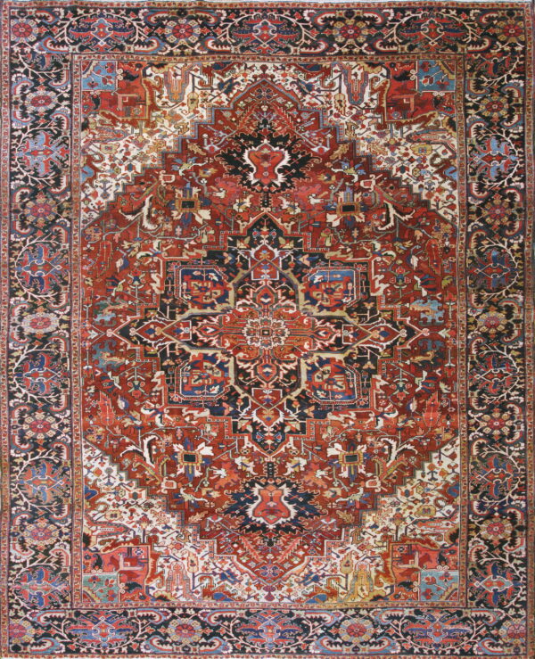 Highly detailed rug displaying a large geometric medallion pattern in deep red, black, blue, and cream colors.