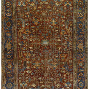 Intricate traditional rug featuring a dark red field, blue borders, and detailed gold and blue floral designs.