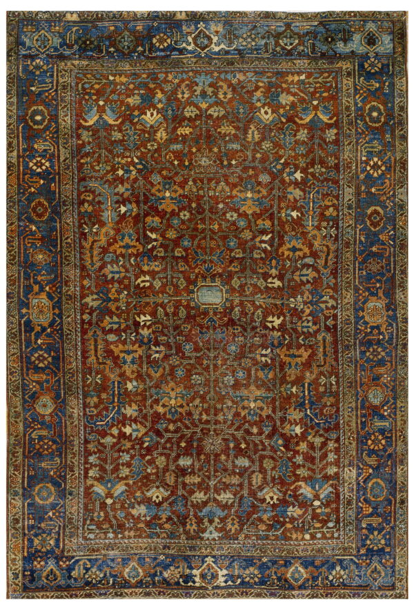 Intricate traditional rug featuring a dark red field, blue borders, and detailed gold and blue floral designs.