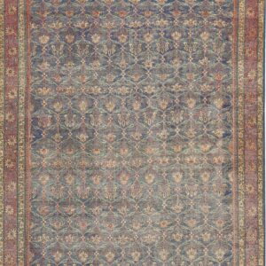 A deeply faded blue rug featuring an all-over distressed floral lattice and a wide rust red border.